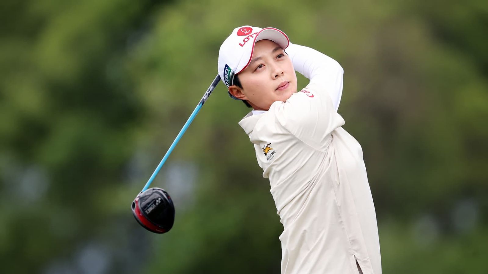 Golfer completing a drive with a golf shaft